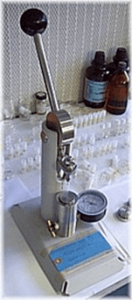 Press used to compact graphite into sample plug for the AMS sample wheel.