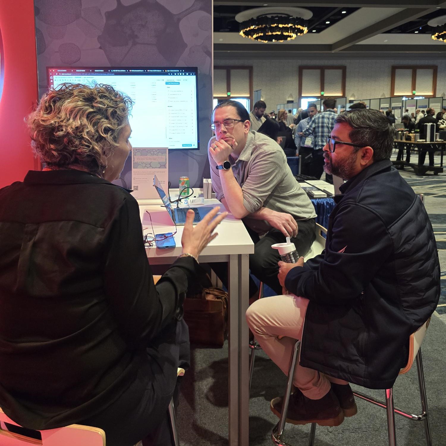 Individuals sitting at a booth for a demo